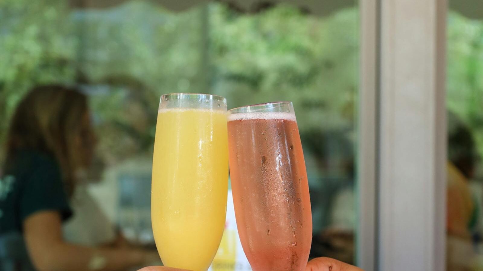 Two guests toasting mimosas at The Breakfast Company in Sarasota