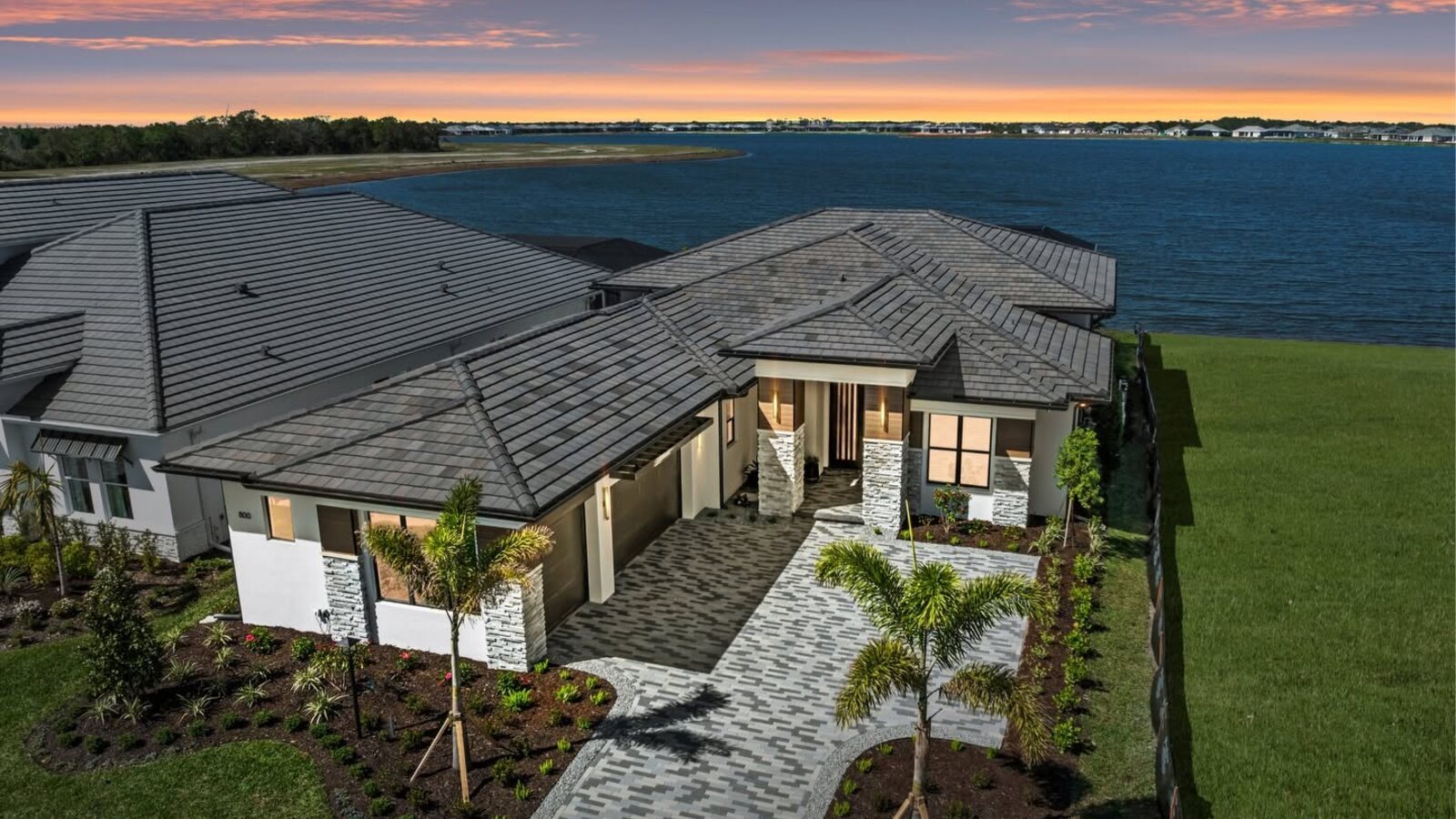 A custom luxury home built by Lee Wetherington Homes in the Sarasota area at dusk