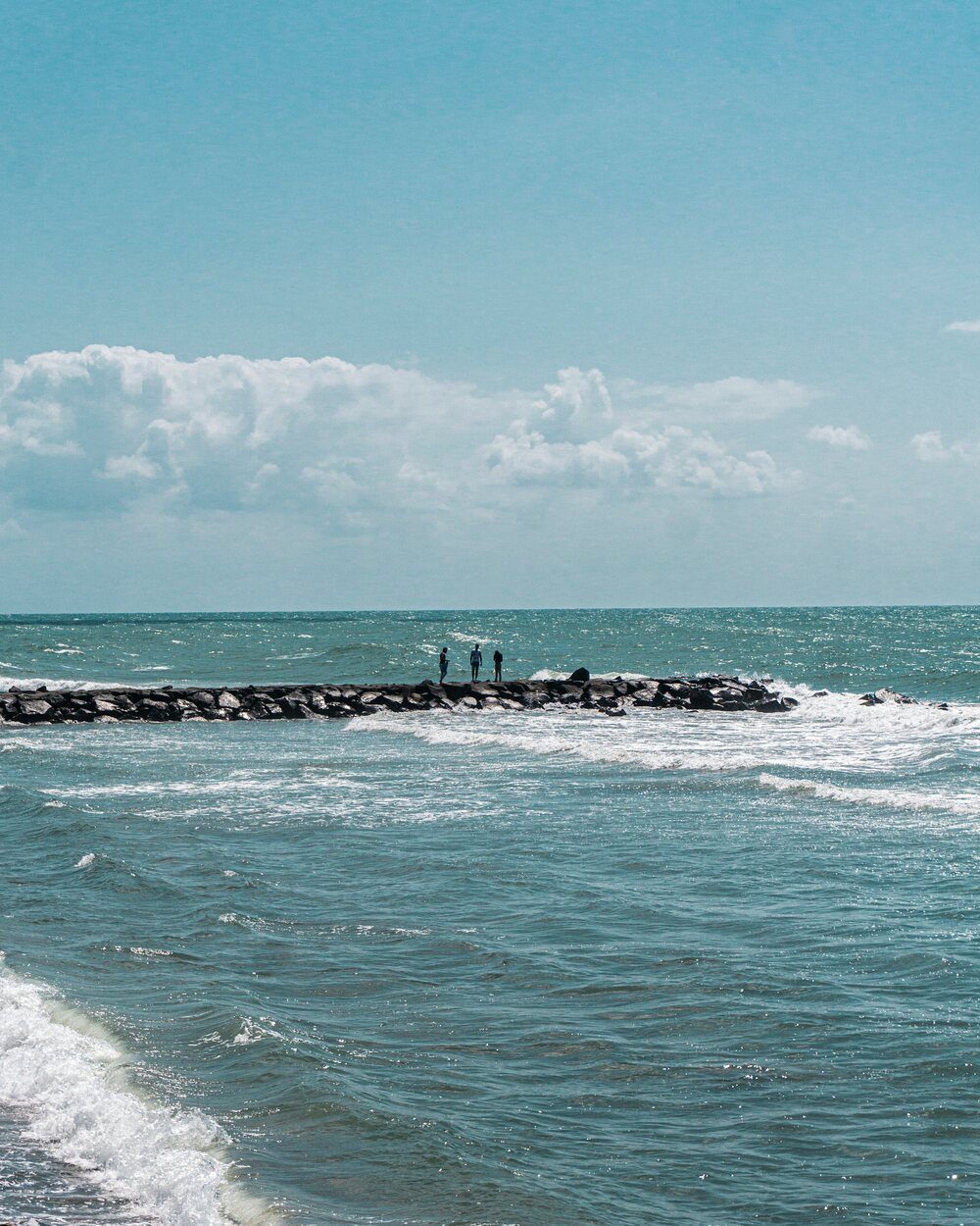 Turquoise Gulf water and a rock jetty on the Sarasota coast